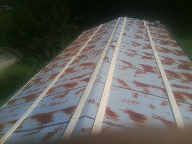 Rusted metal roof panels with new wood purlins before replacement — Storm Damage Roof Repair in Georgetown by Roofing Brothers